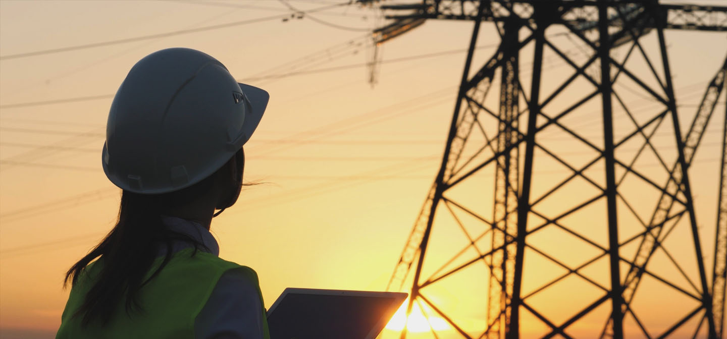 Return of Callide C Power Station - its impact on wholesale and futures spot prices header - Person in Hard Hat looking at power lines