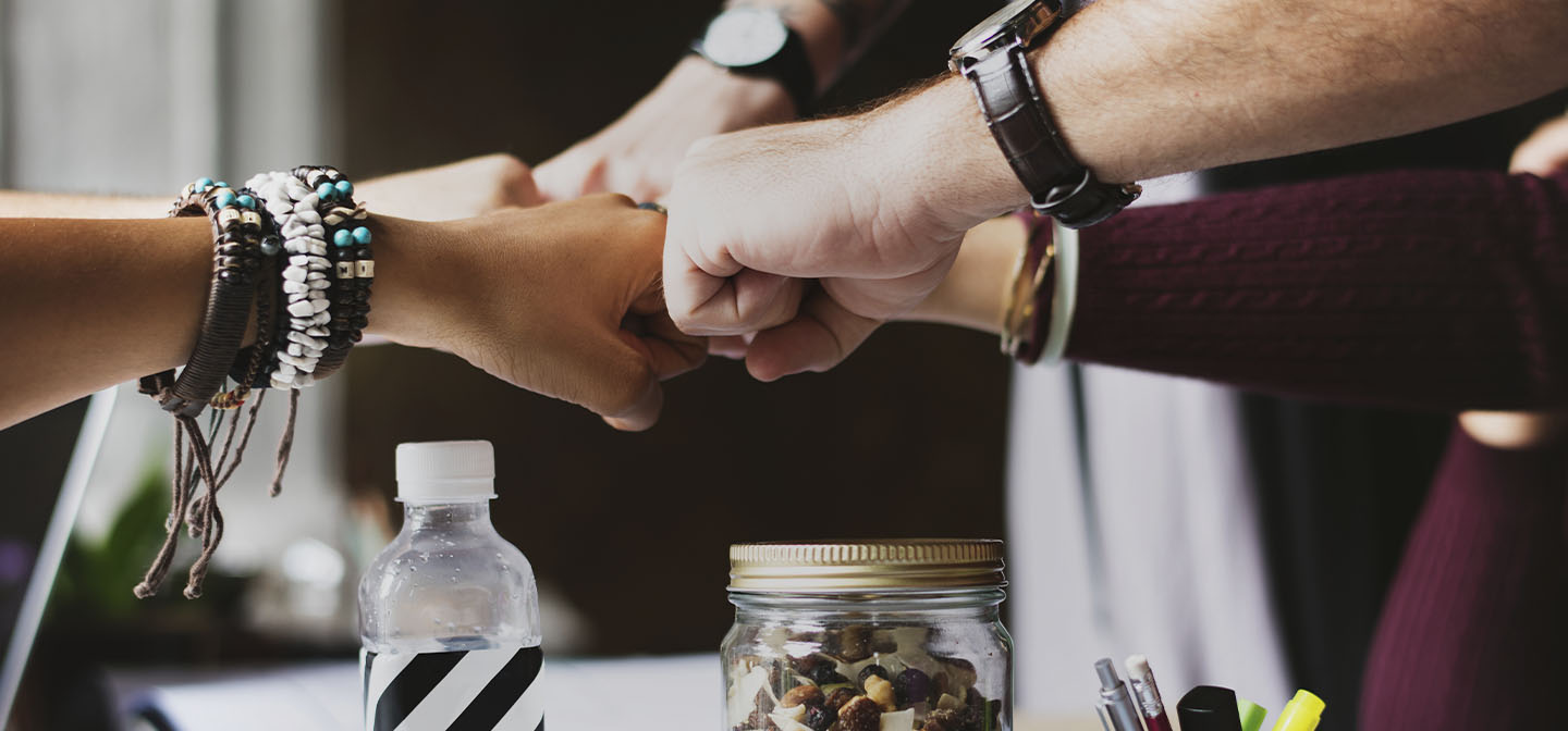 What you need to know about joining an electricity buying group header - group fist bumping